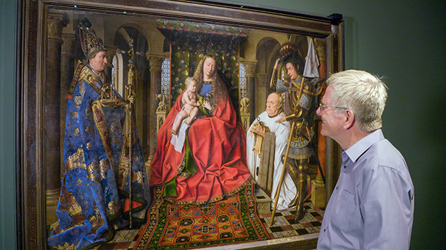 Rick admires Jan van Eyck’s The Virgin and Child with Canon van der Paele (1436) at the Groeninge Museum in Bruges, Belgium.